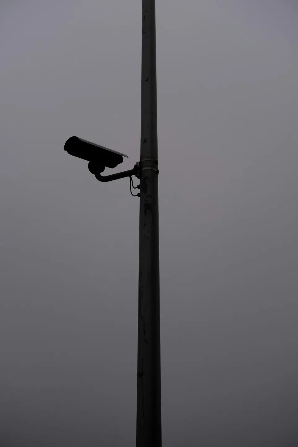 black street light under gray sky